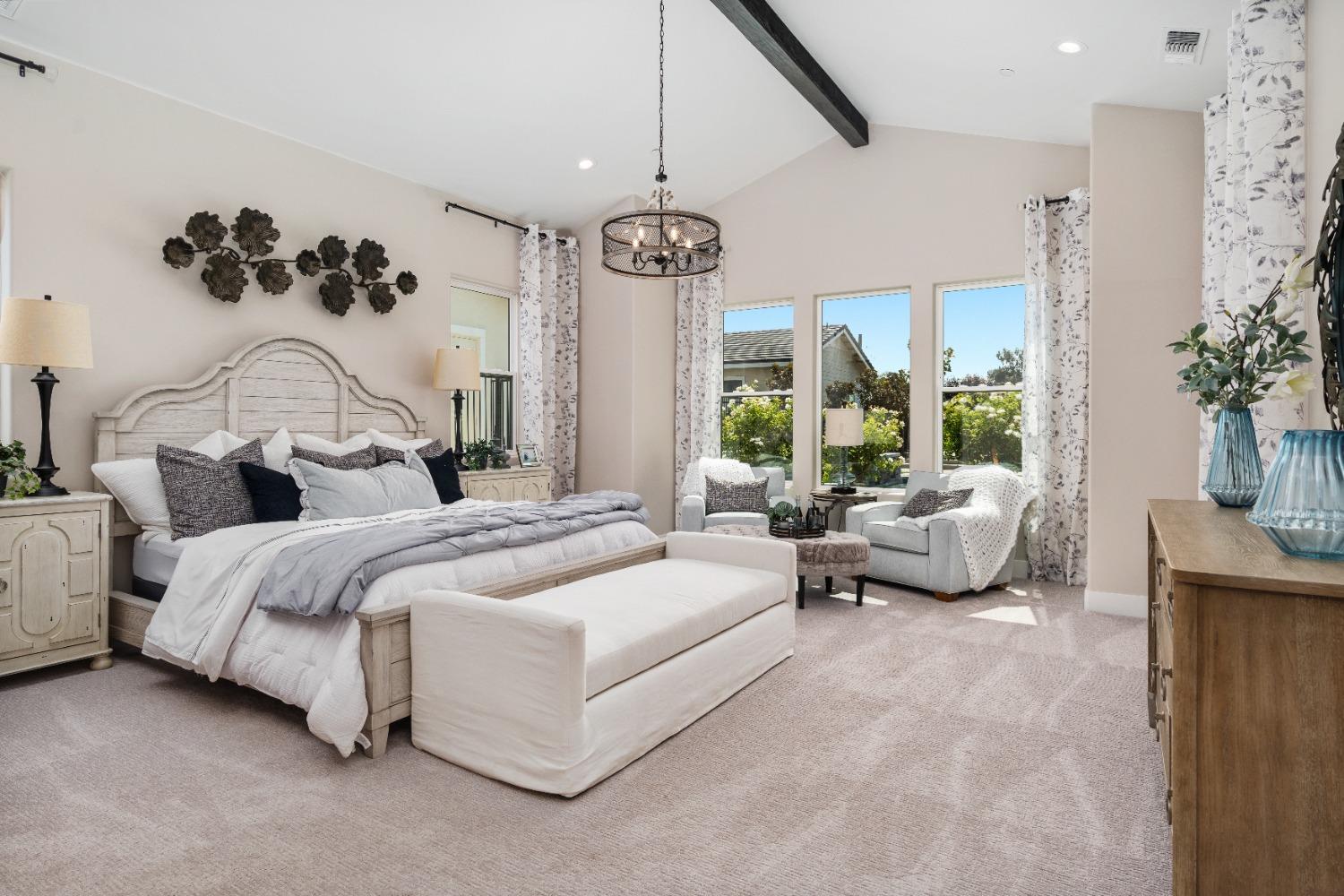 1754 Lester Avenue Clovis, CA 93619 - Photo 36 of 59 a spacious bedroom with bed and a chandelier