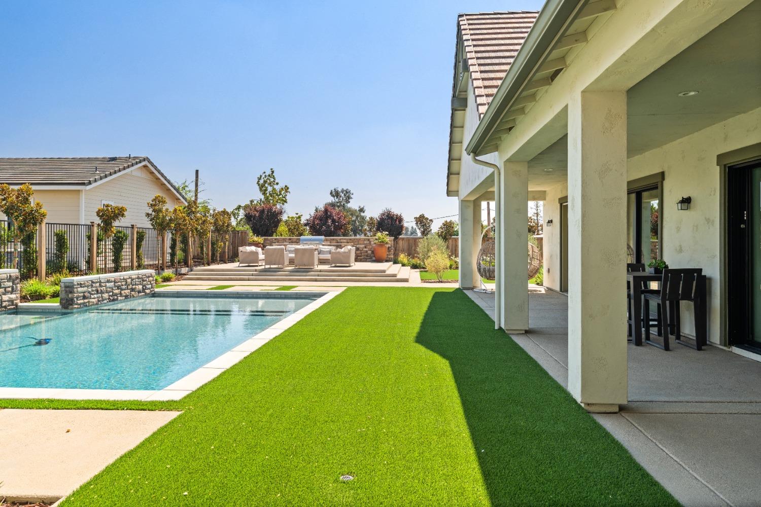 1754 Lester Avenue Clovis, CA 93619 - Photo 54 of 59 a view of a swimming pool with a lawn chairs