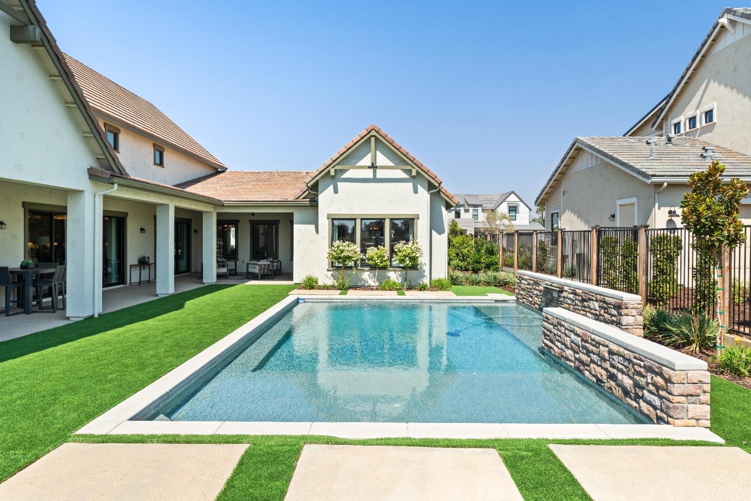 1754 Lester Avenue Clovis, CA 93619 - Photo 55 of 59 a view of swimming pool with lawn chairs and large trees