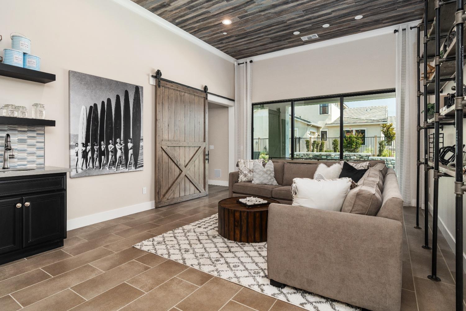 1754 Lester Avenue Clovis, CA 93619 - Photo 10 of 59 a living room with furniture a large window and a wooden door