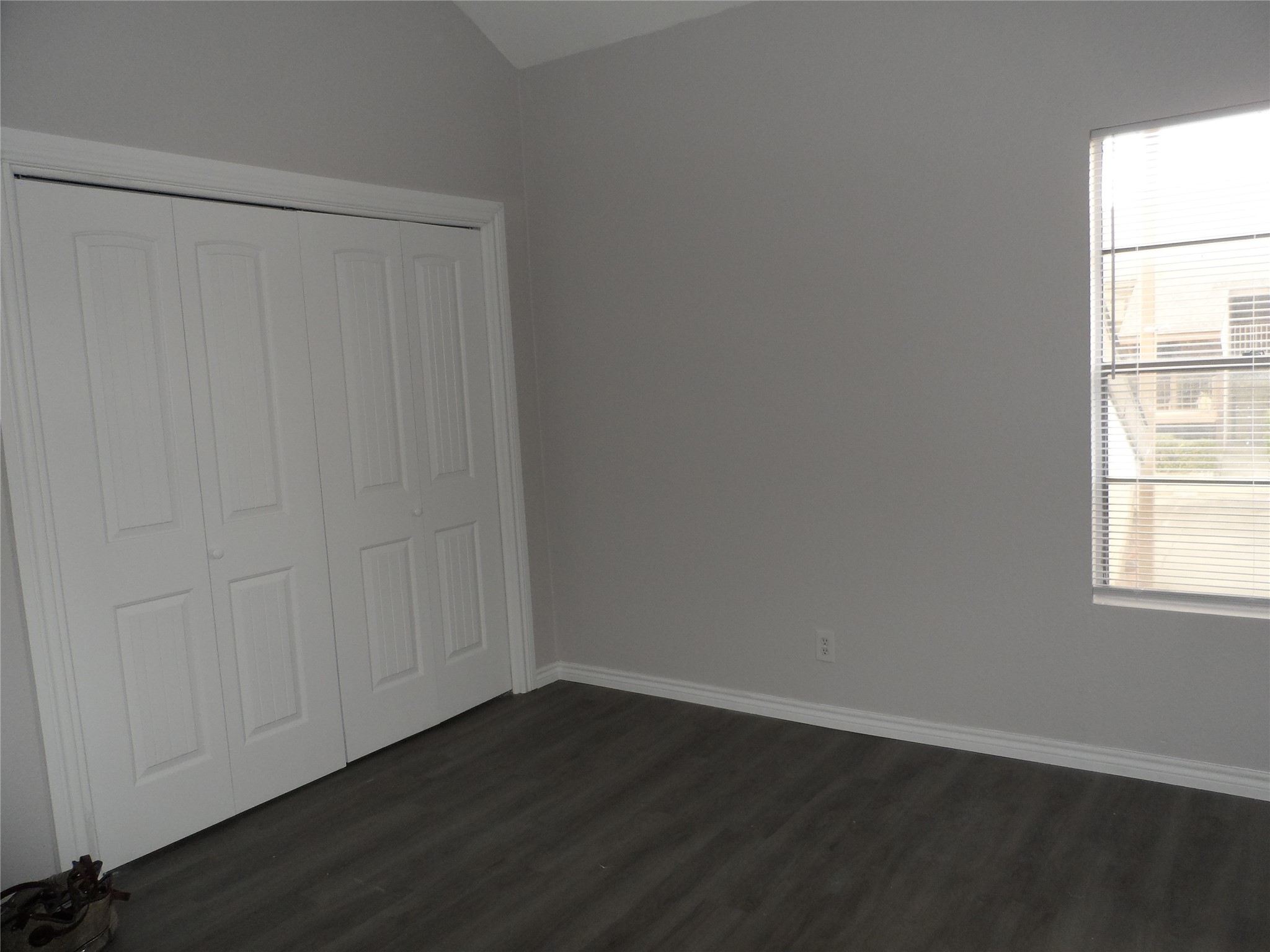 12900 Walden Road, Unit 618F Montgomery, TX 77356 - Photo 7 of 19 an empty room with wooden floor and windows with curtains