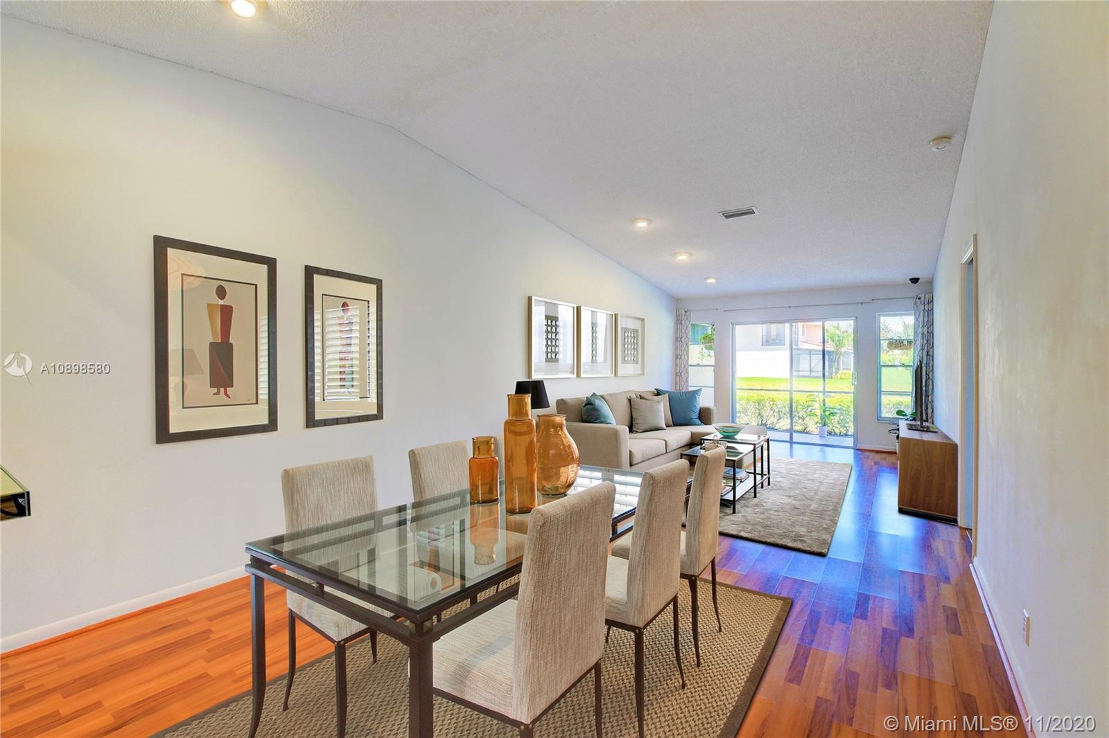 8617 Sunbird Place, Unit B Boca Raton, FL 33496 - Photo 1 of 41 a living room with furniture and wooden floor