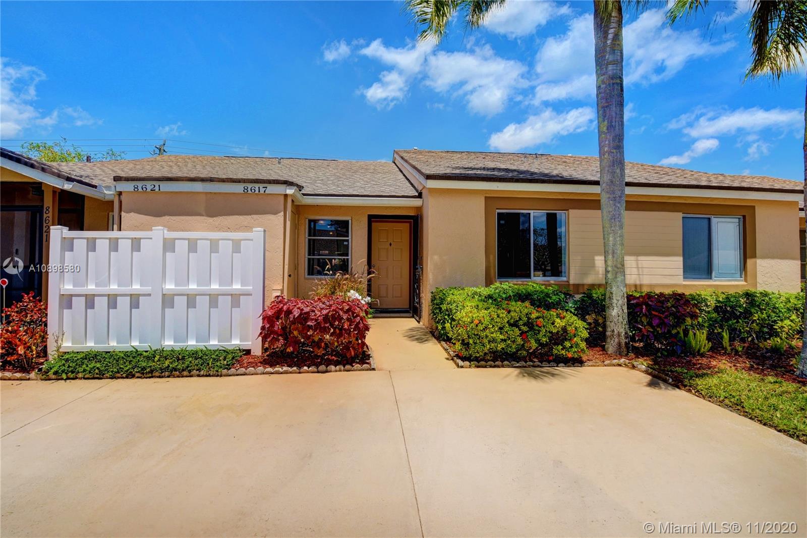 8617 Sunbird Place, Unit B Boca Raton, FL 33496 - Photo 19 of 41 a front view of a house with garden