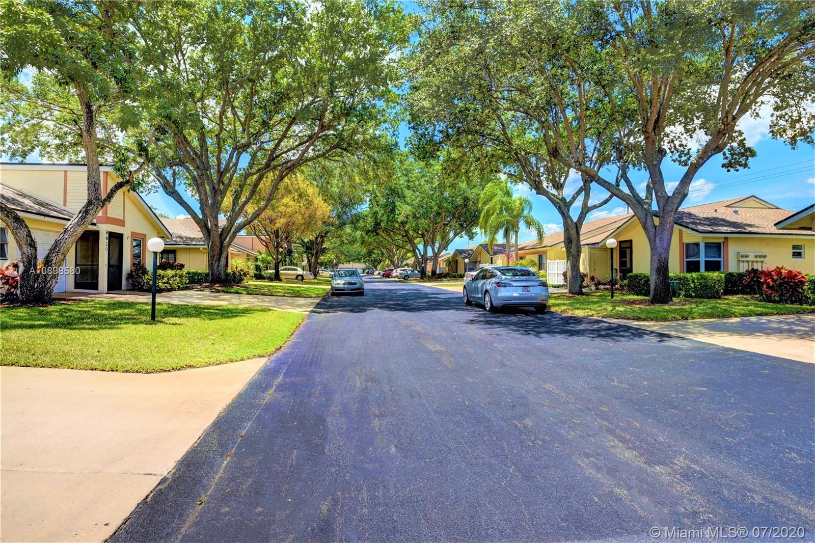8617 Sunbird Place, Unit B Boca Raton, FL 33496 - Photo 20 of 41 a house with trees in the background