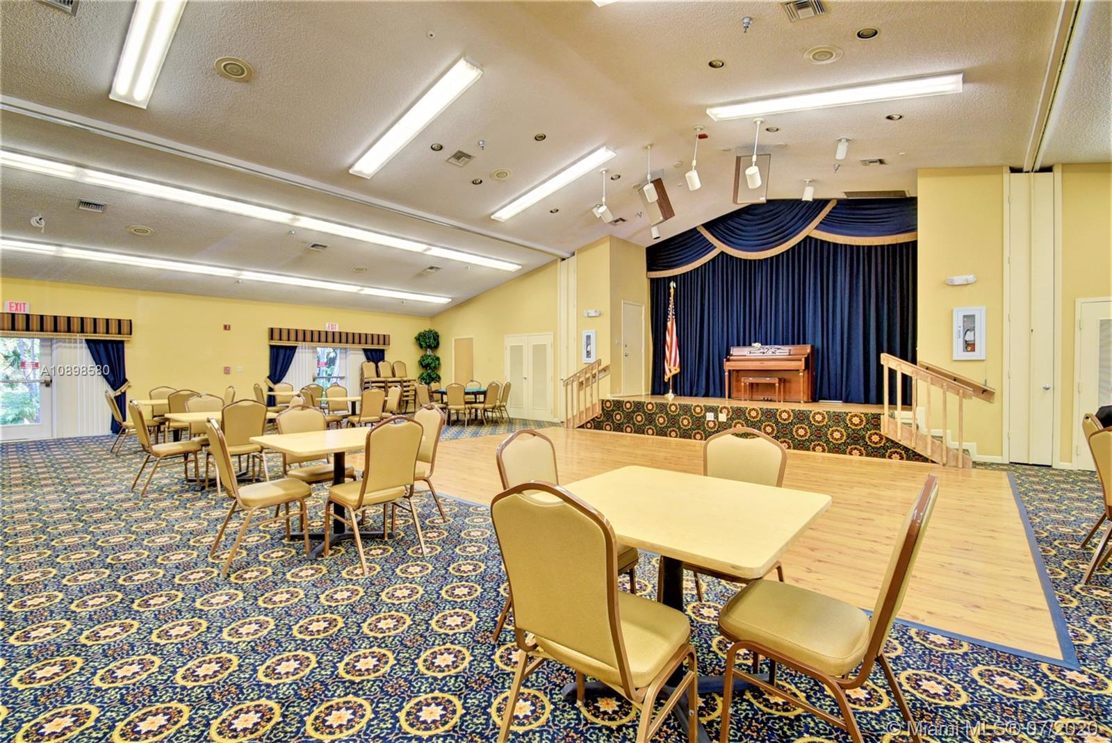 8617 Sunbird Place, Unit B Boca Raton, FL 33496 - Photo 29 of 41 a living room with lots of chairs and a table