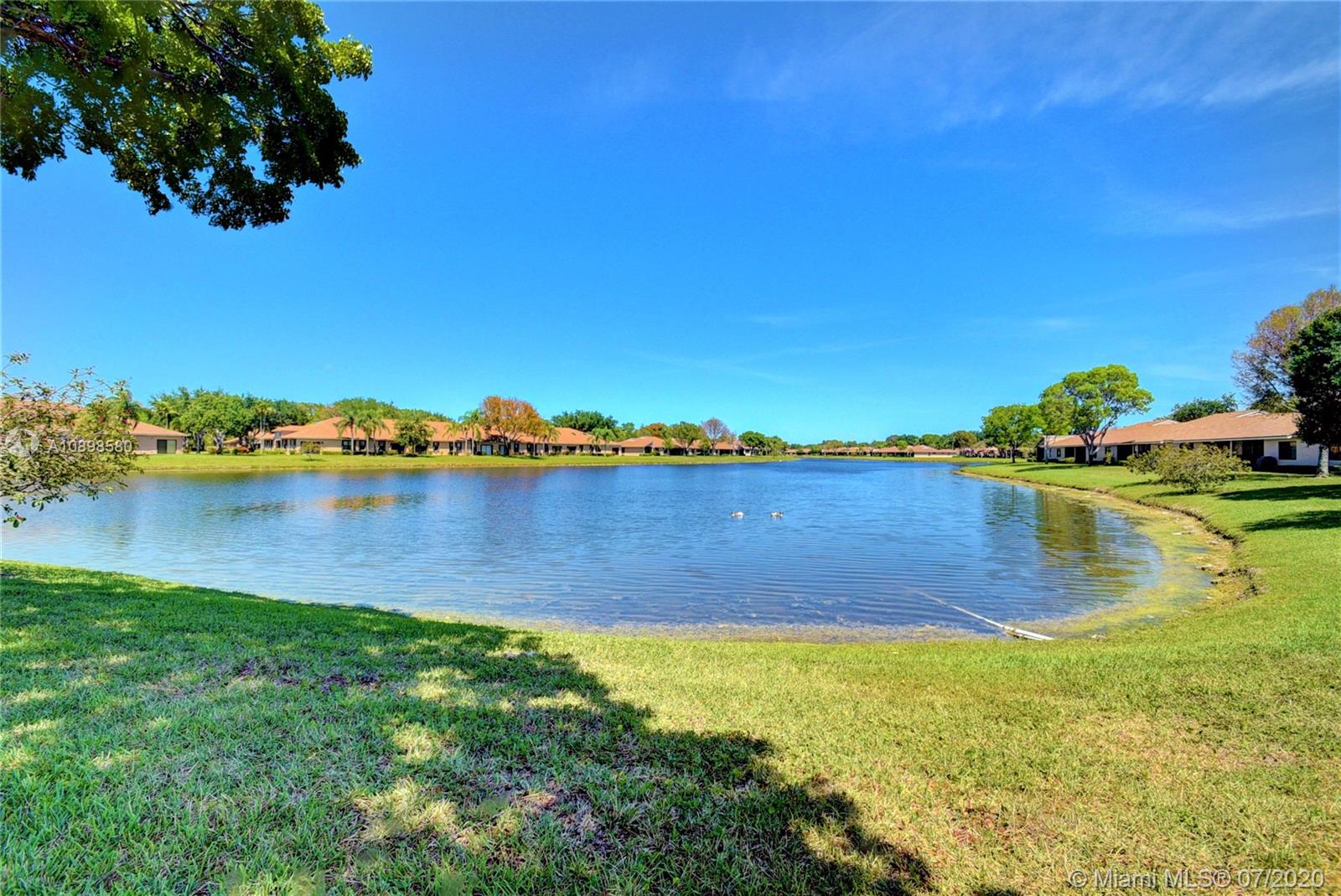 8617 Sunbird Place, Unit B Boca Raton, FL 33496 - Photo 35 of 41 a view of a lake with houses in the back