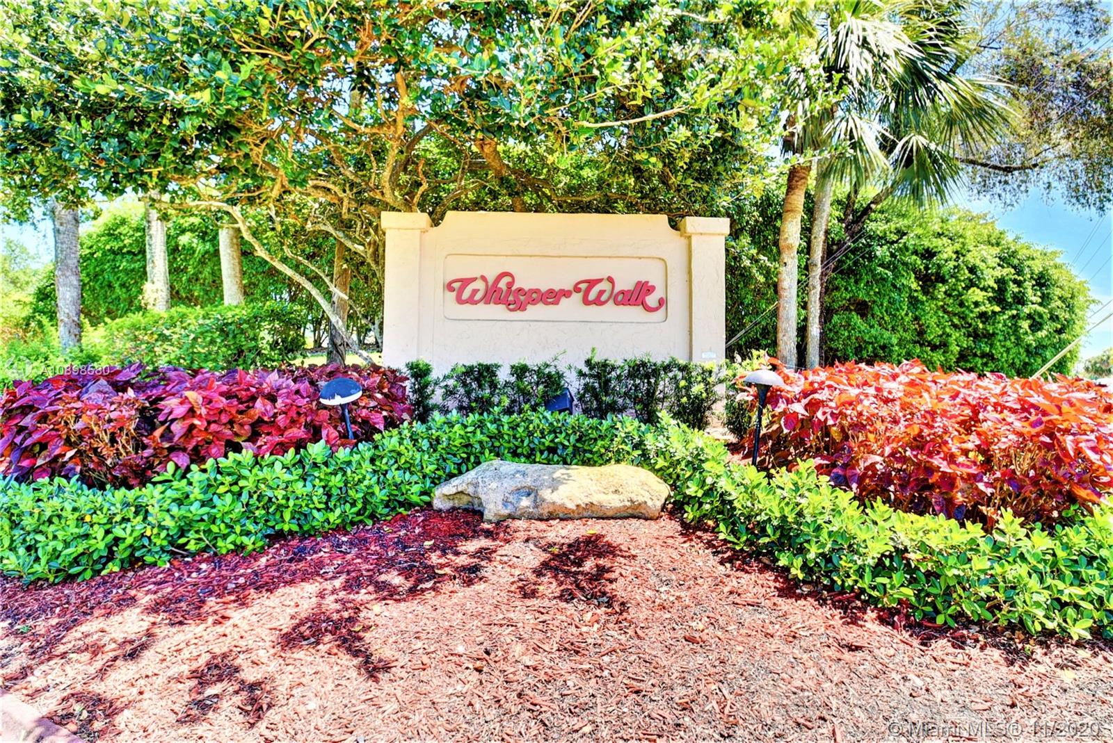 8617 Sunbird Place, Unit B Boca Raton, FL 33496 - Photo 36 of 41 a sign that is in front of flowers