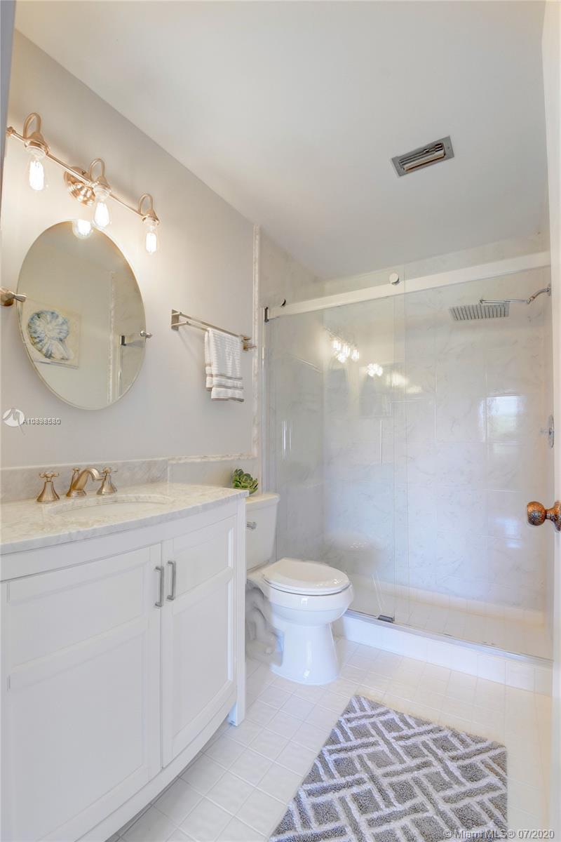 8617 Sunbird Place, Unit B Boca Raton, FL 33496 - Photo 38 of 41 a bathroom with a sink a toilet and bathtub