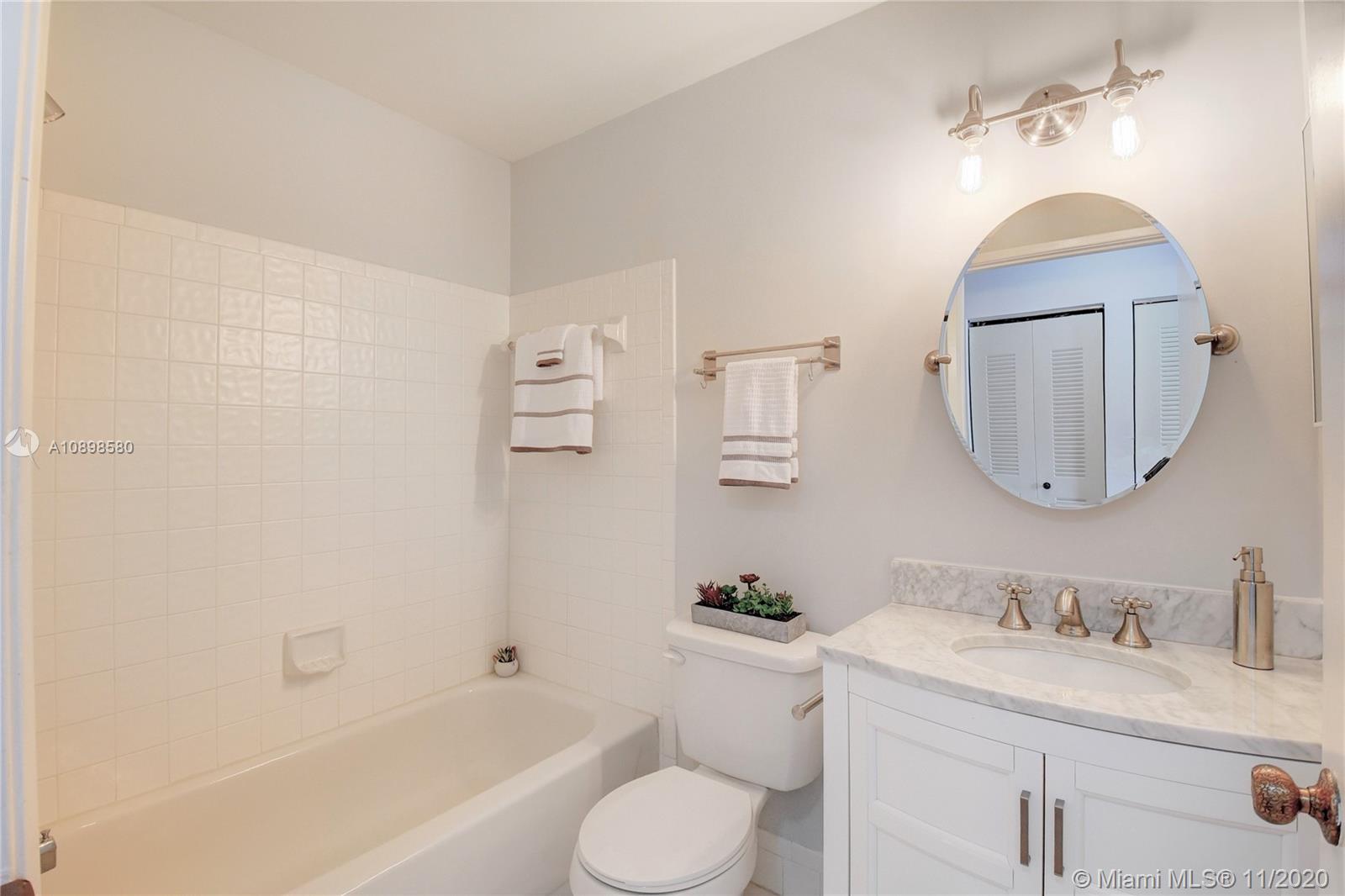 8617 Sunbird Place, Unit B Boca Raton, FL 33496 - Photo 39 of 41 a bathroom with a granite countertop sink toilet and a mirror