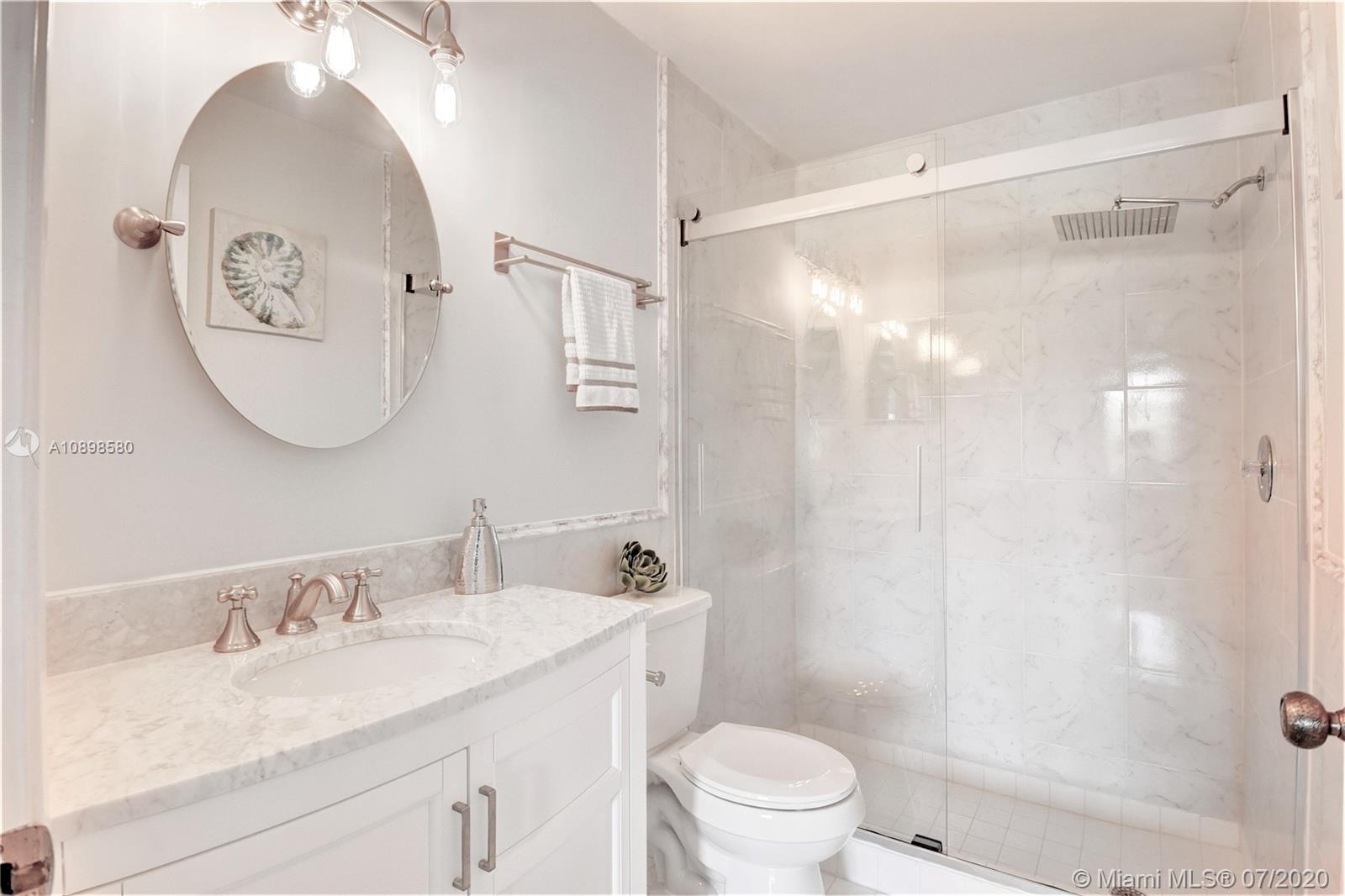 8617 Sunbird Place, Unit B Boca Raton, FL 33496 - Photo 5 of 41 a bathroom with a granite countertop sink toilet and shower