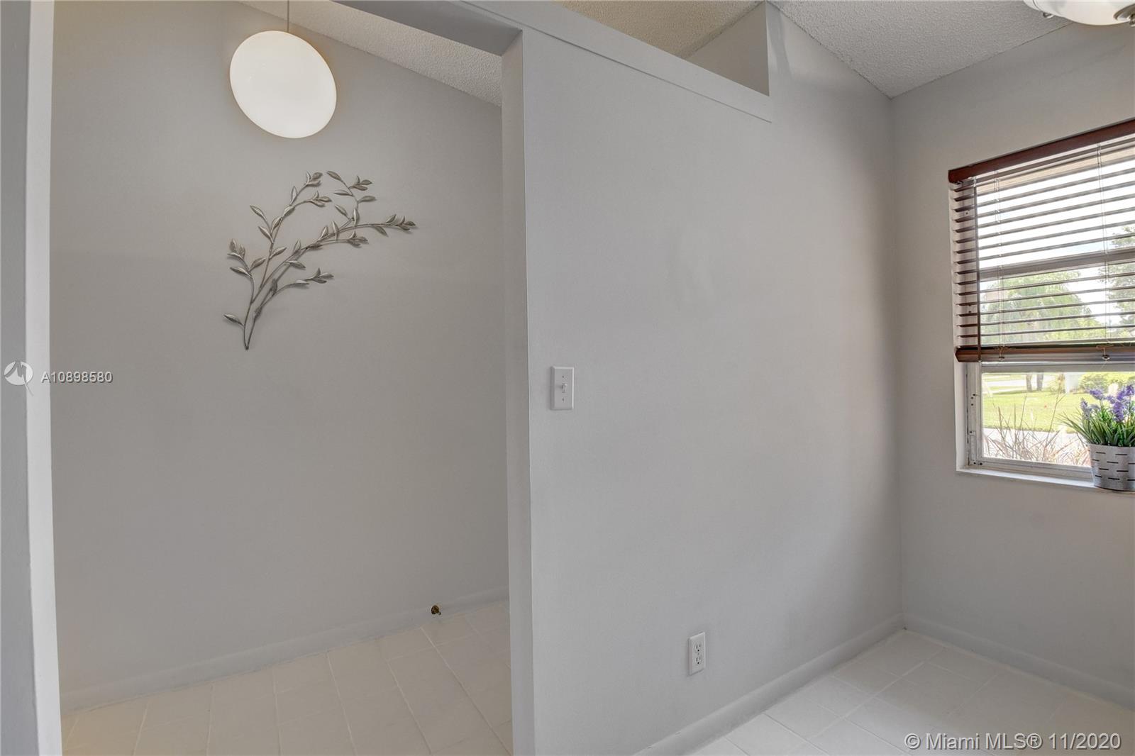8617 Sunbird Place, Unit B Boca Raton, FL 33496 - Photo 6 of 41 a bathroom with a window and a shower curtain