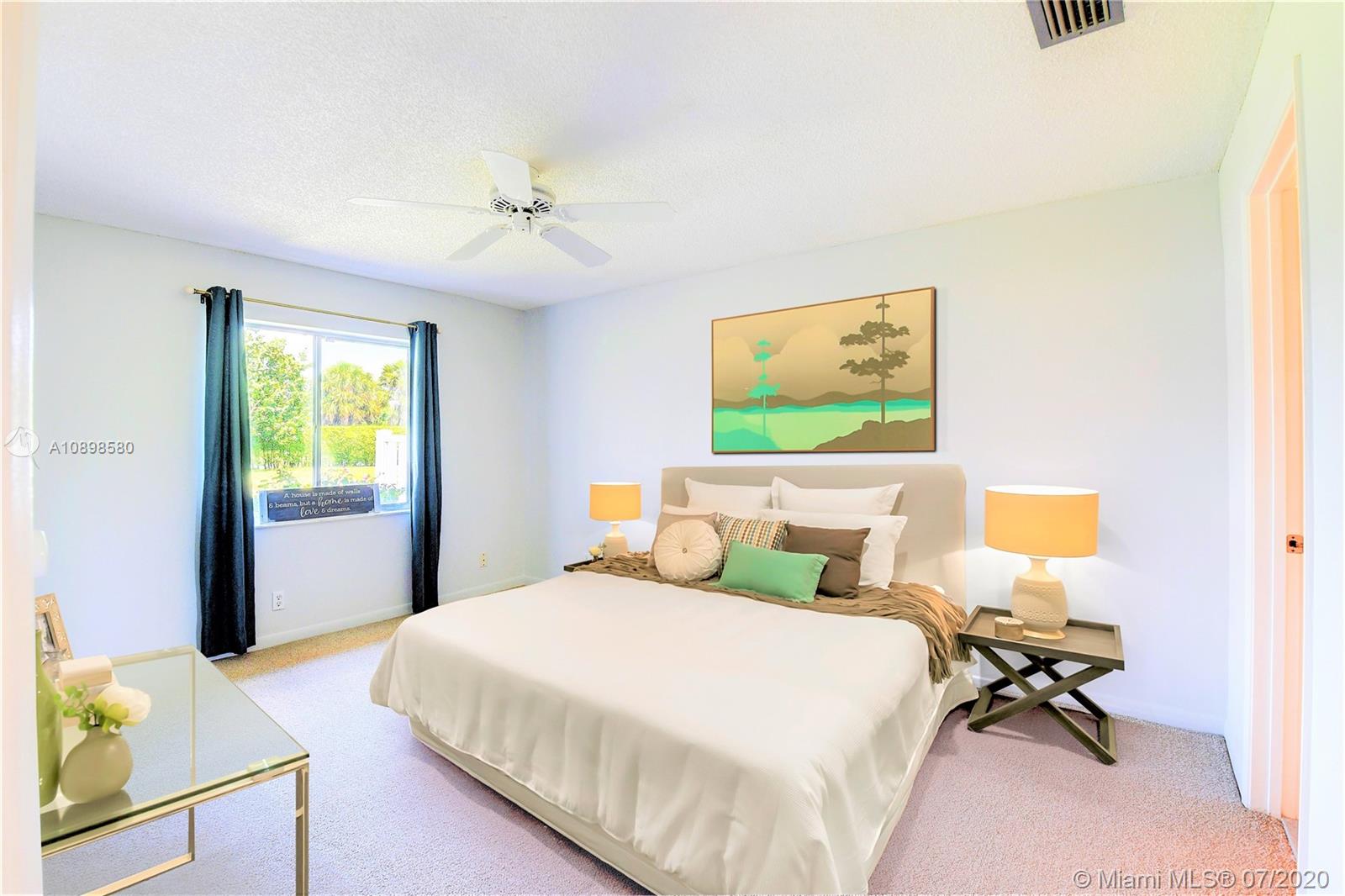 8617 Sunbird Place, Unit B Boca Raton, FL 33496 - Photo 8 of 41 a bedroom with a bed and a desk
