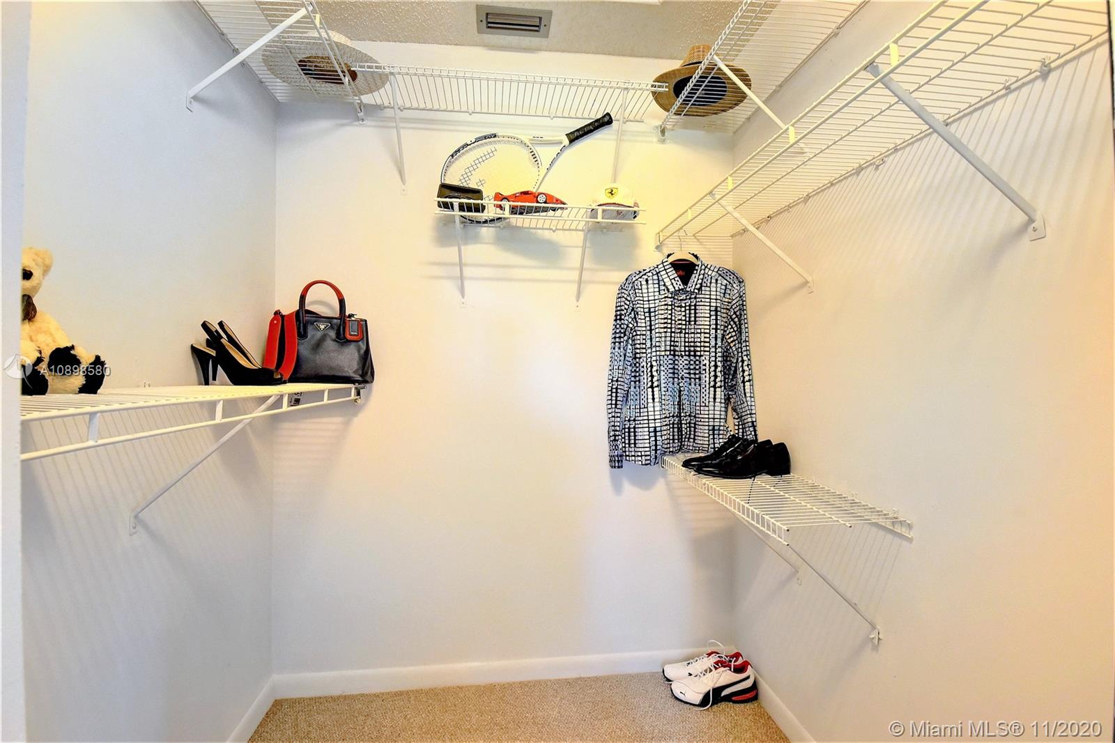 8617 Sunbird Place, Unit B Boca Raton, FL 33496 - Photo 9 of 41 a view of walk in closet with clothes and shoes