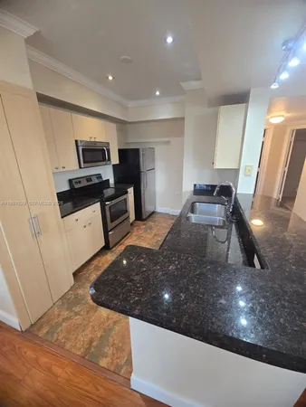 a kitchen with sink a stove and refrigerator