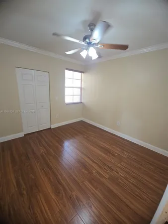 a view of wooden floor and windows in a room