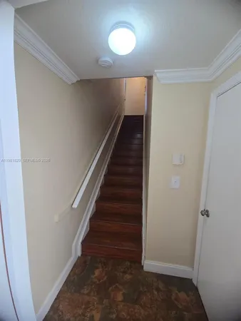 a view of entryway with stairs and wooden floor