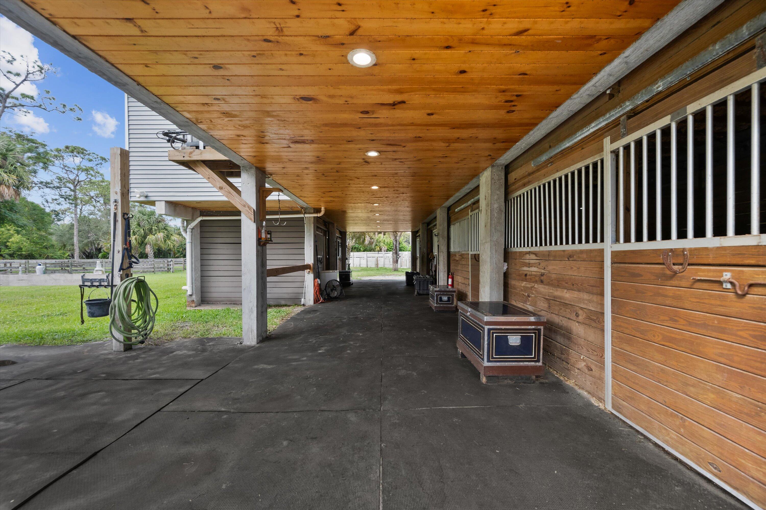 3509 C Road, Unit BARN Loxahatchee Groves, FL 33470 - Photo 2 of 12 a view of a porch with furniture and a backyard