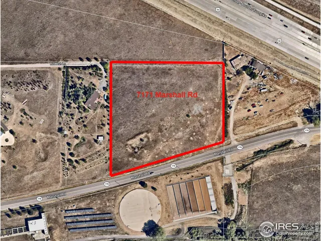 a view of a garden with a building in the background