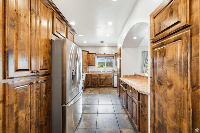 7776 Wagon Road East St. George, UT 84770 - Photo 13 of 76 Kitchen featuring stainless steel refrigerator with ice dispenser, light countertops, recessed lighting, and wood finish cabinetry
