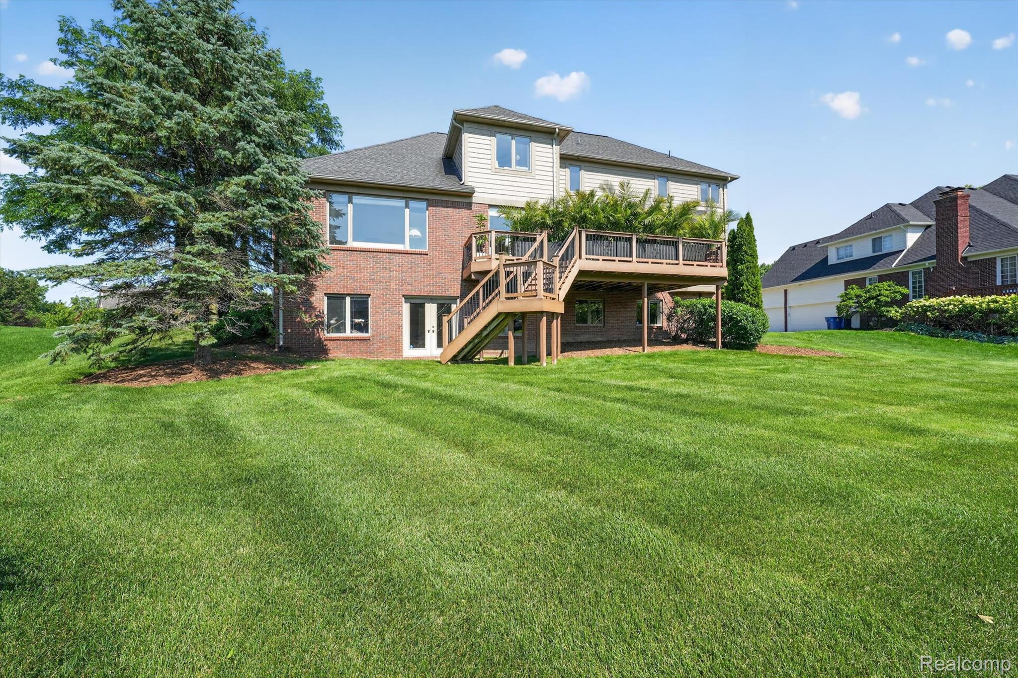 3804 Elk Drive Rochester, MI 48306 - Photo 56 of 75 Expansive green lawn sloping towards a multi-level dwelling