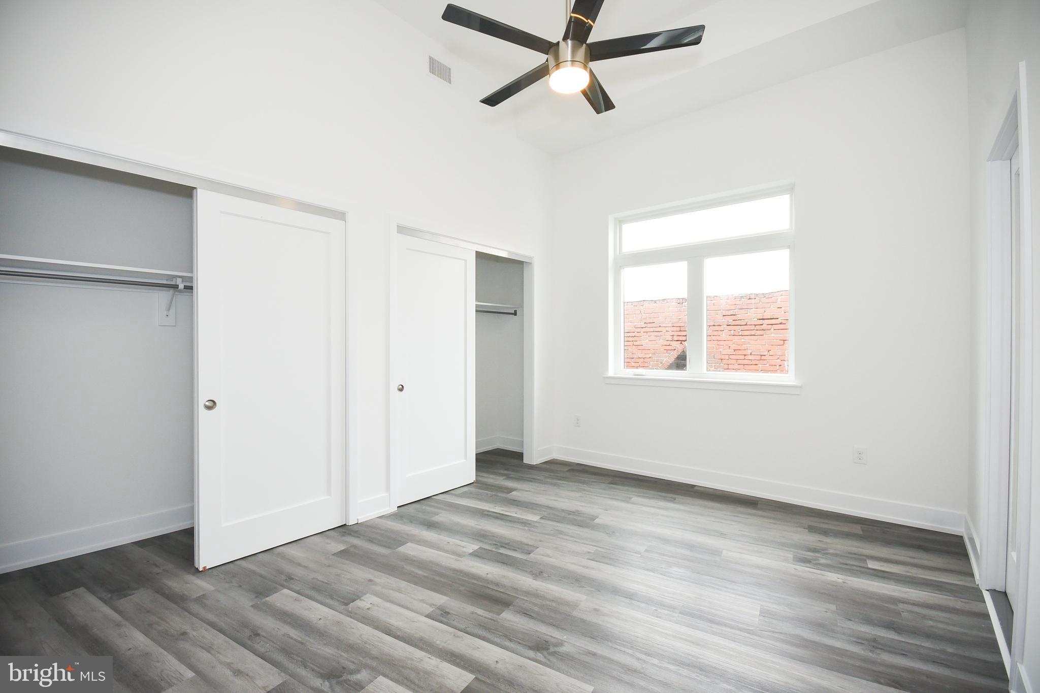 6164-66 Ridge Avenue, Unit 301 Philadelphia, PA 19128 - Photo 6 of 8 a view of a room with wooden floor closet and windows