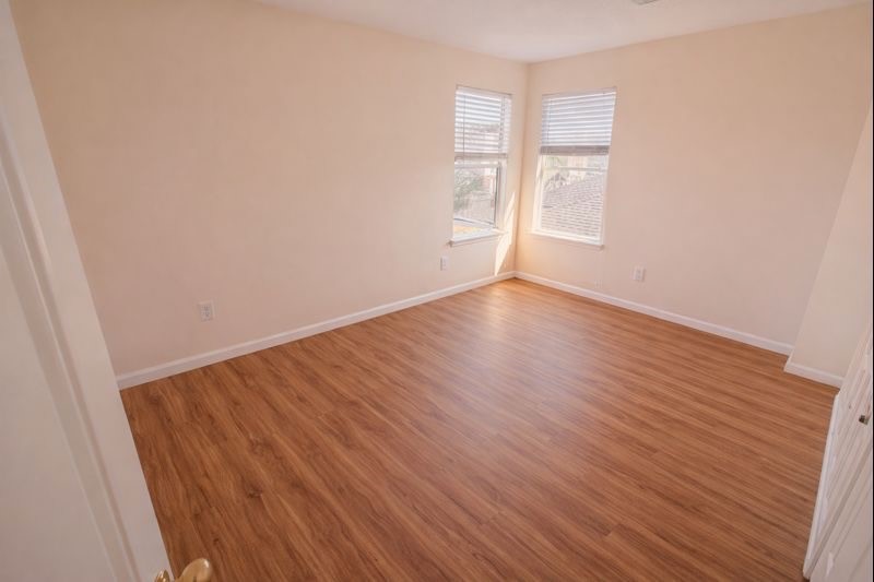 13131 Leader Trail Houston, TX 77072 - Photo 11 of 17 an empty room with wooden floor and windows