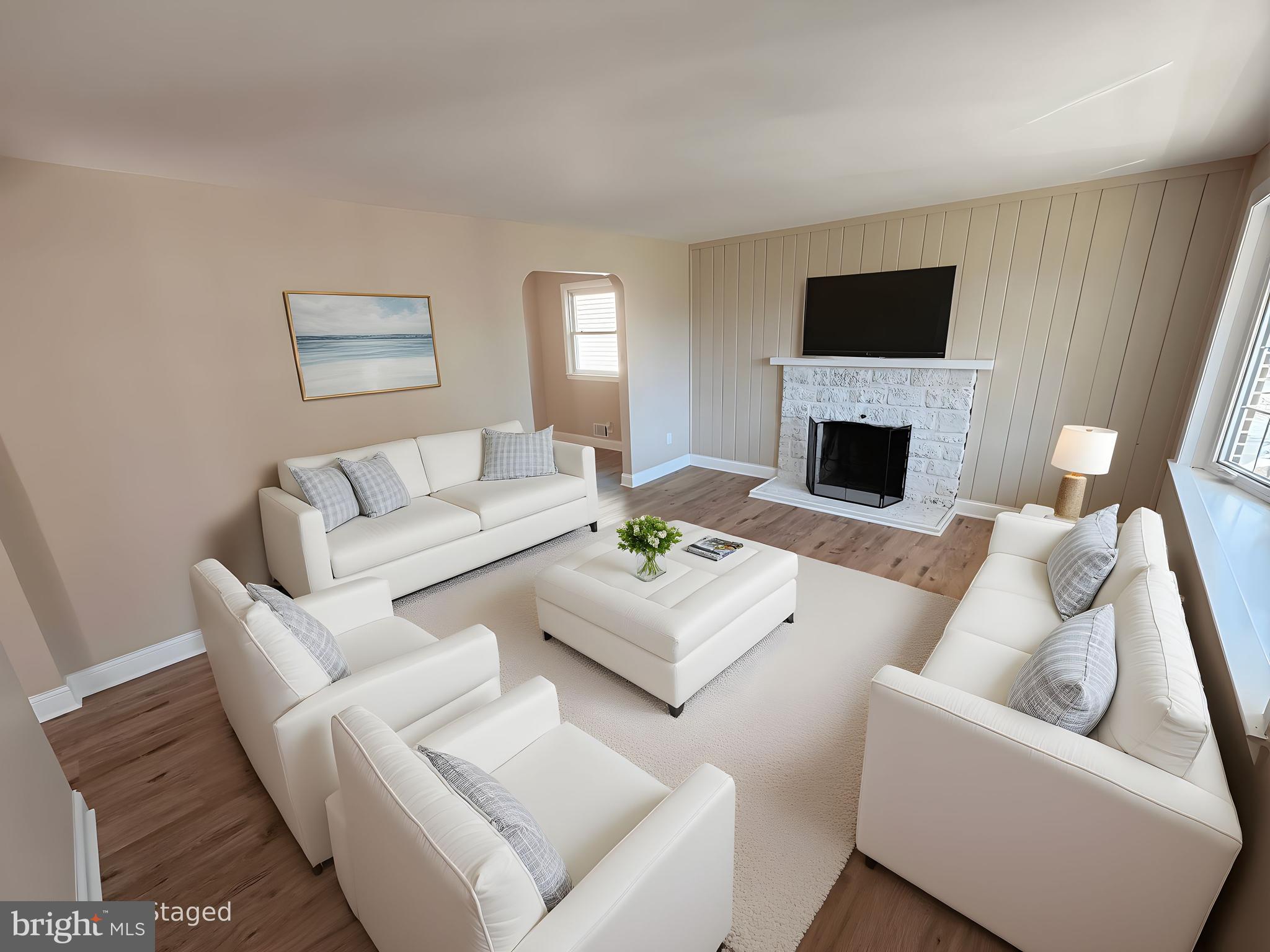 a living room with furniture a fireplace and a flat screen tv