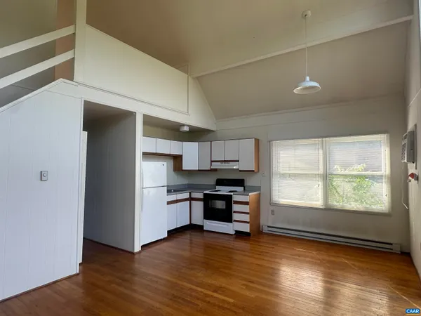 a kitchen with stainless steel appliances a stove top oven a sink and a window