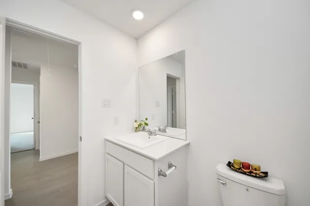 a bathroom with a sink vanity and a mirror