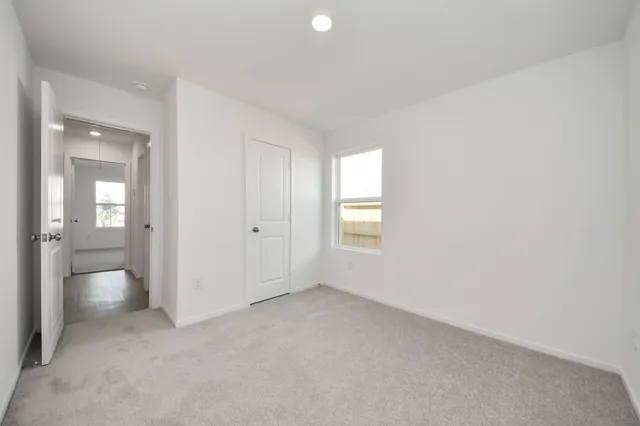 an empty room with a bathroom and a sink