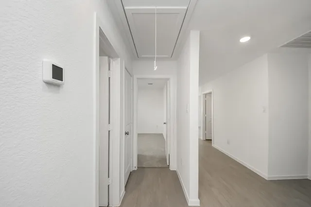 a view of a hallway with a white walls