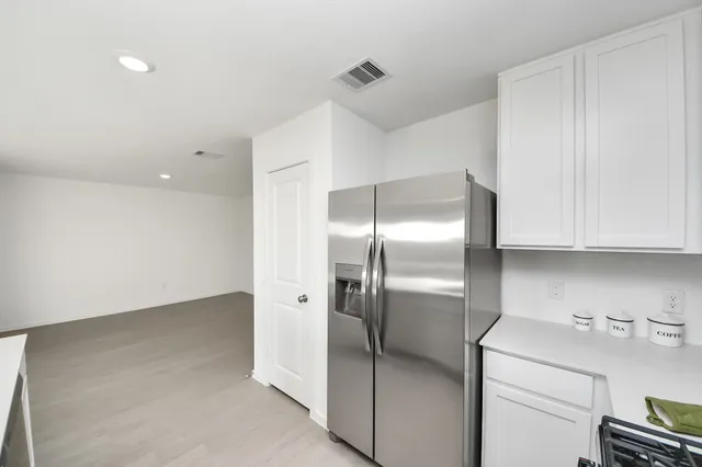 a kitchen with a refrigerator and cabinets