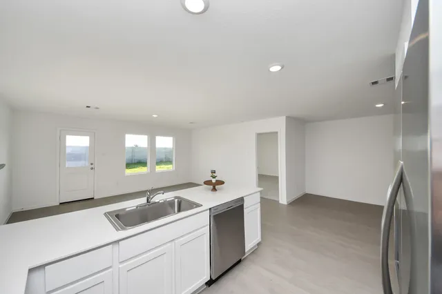 a kitchen with a sink and cabinets