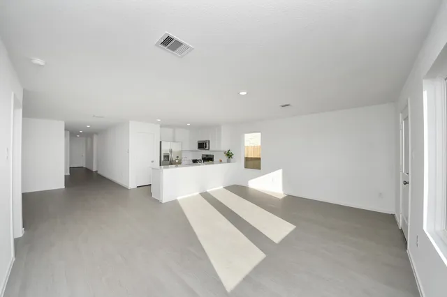 a view of kitchen and hall with stainless steel appliances