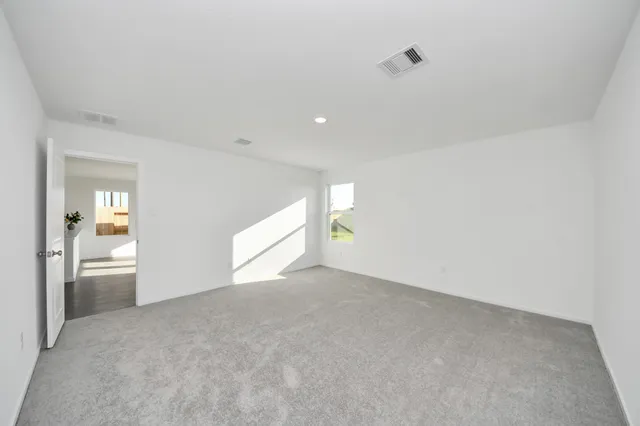 a view of an empty room and a window