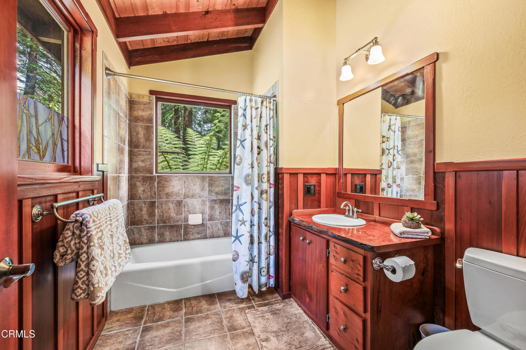 32450 Simpson Lane Fort Bragg, CA 95437 - Photo 21 of 54 a bathroom with a sink a toilet a mirror and bathtub