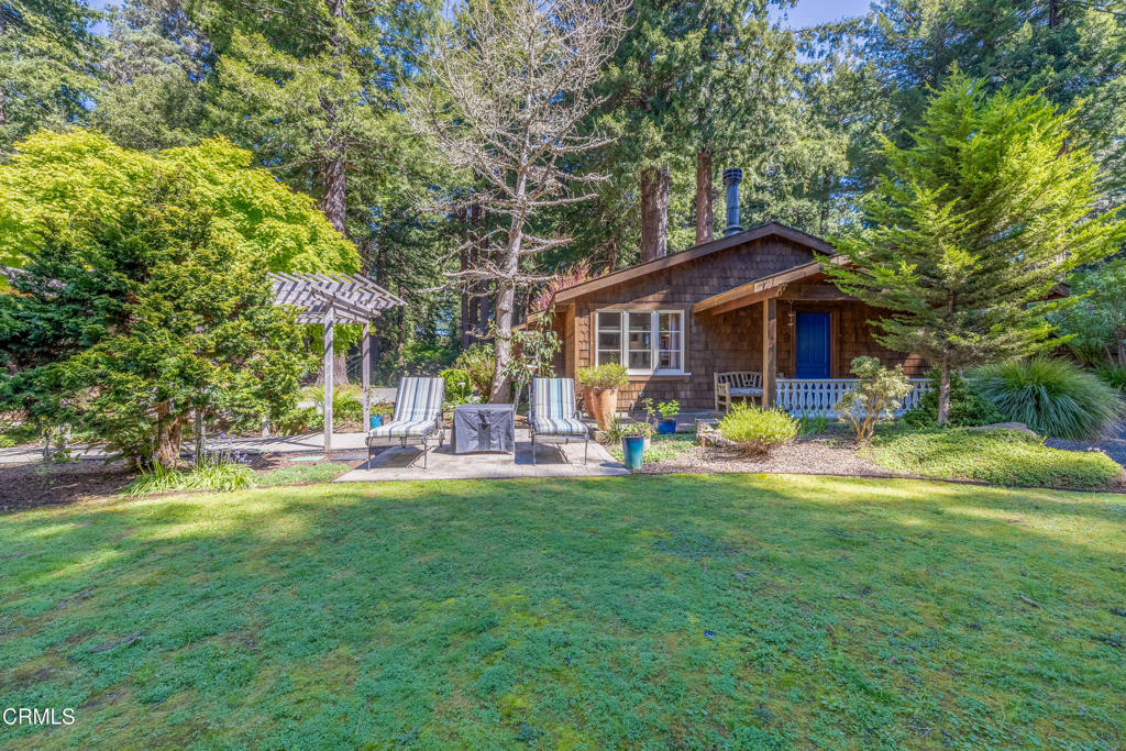 32450 Simpson Lane Fort Bragg, CA 95437 - Photo 3 of 54 a front view of a house with patio and garden