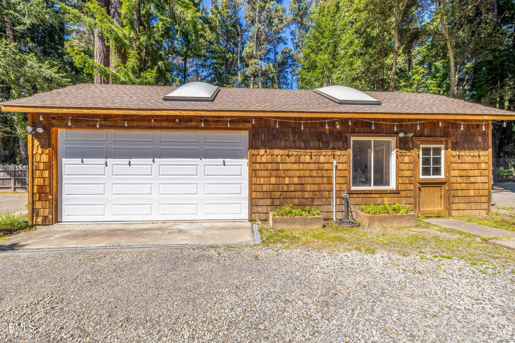 32450 Simpson Lane Fort Bragg, CA 95437 - Photo 38 of 54 a front view of a house with a yard and garage