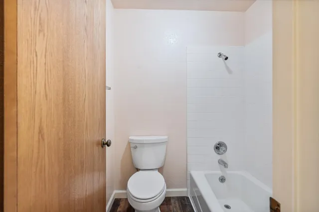 a white toilet sitting next to a bathroom sink