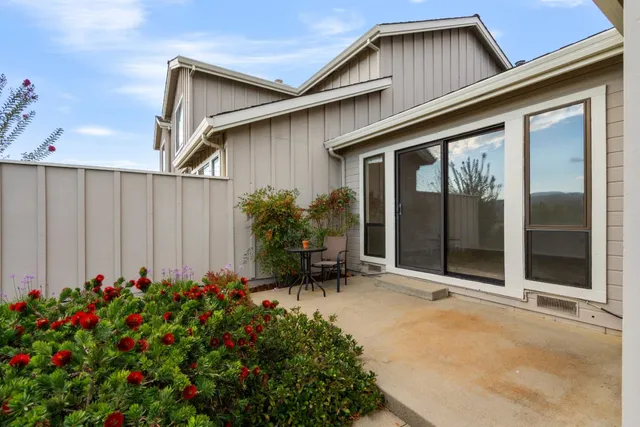 a view of a house with porch and garden