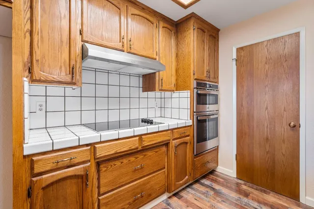 a kitchen with a refrigerator and cabinets