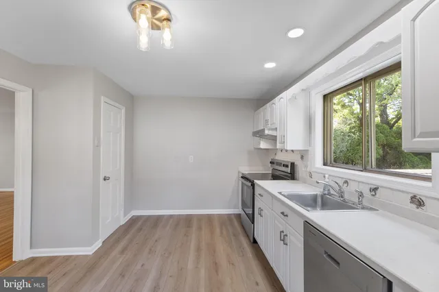 a view of a kitchen sink and a window