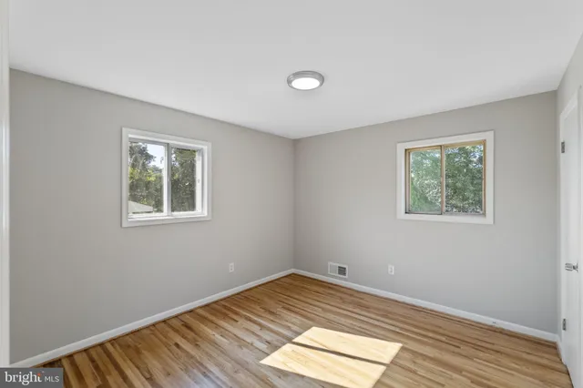 a view of a room with wooden floor and window