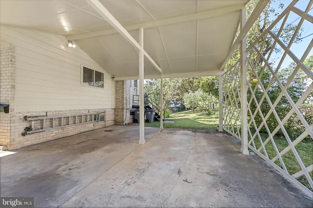 a view of a porch with wooden floor and fence