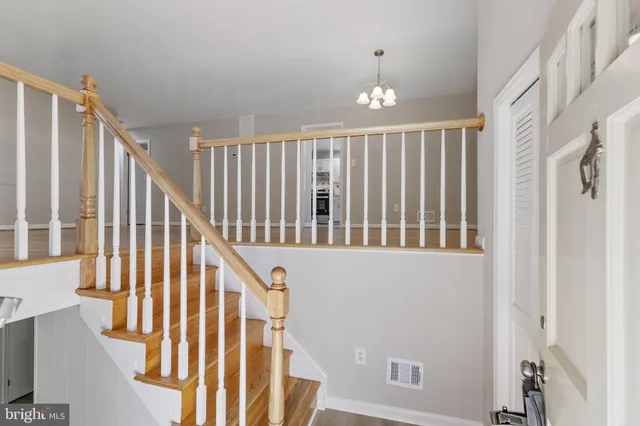 a view of staircase with railing and a window