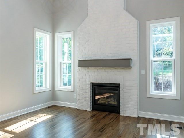 6920 Ray Family Farm Court, Unit LT20 Raleigh, NC 27613 - Photo 14 of 22 a view of an empty room with wooden floor and a window