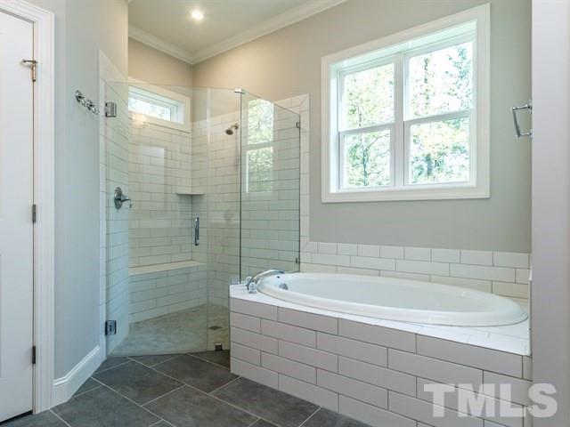 6920 Ray Family Farm Court, Unit LT20 Raleigh, NC 27613 - Photo 17 of 22 a white bath tub sitting next to a shower