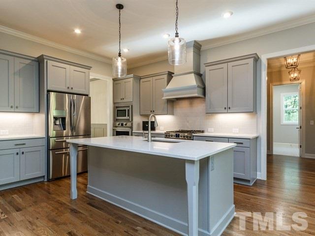6920 Ray Family Farm Court, Unit LT20 Raleigh, NC 27613 - Photo 4 of 22 a kitchen with stainless steel appliances granite countertop a sink a stove and a refrigerator