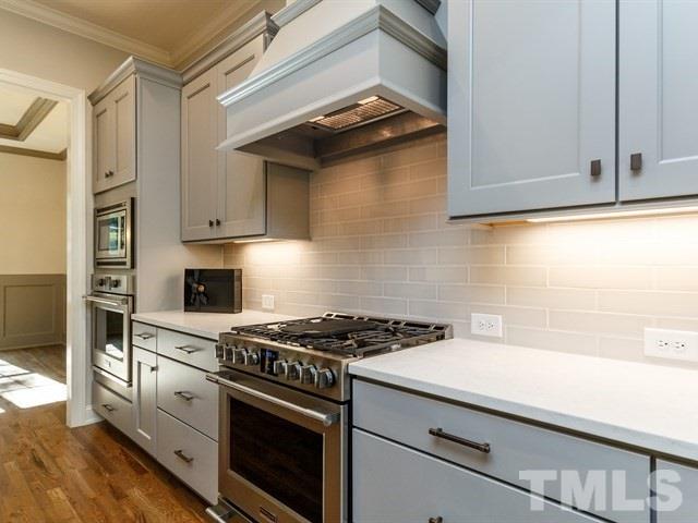 6920 Ray Family Farm Court, Unit LT20 Raleigh, NC 27613 - Photo 5 of 22 a kitchen with cabinets appliances and a wooden floor