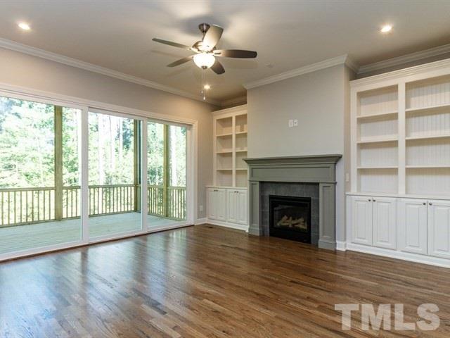 6920 Ray Family Farm Court, Unit LT20 Raleigh, NC 27613 - Photo 6 of 22 a view of an empty room with wooden floor and a fireplace